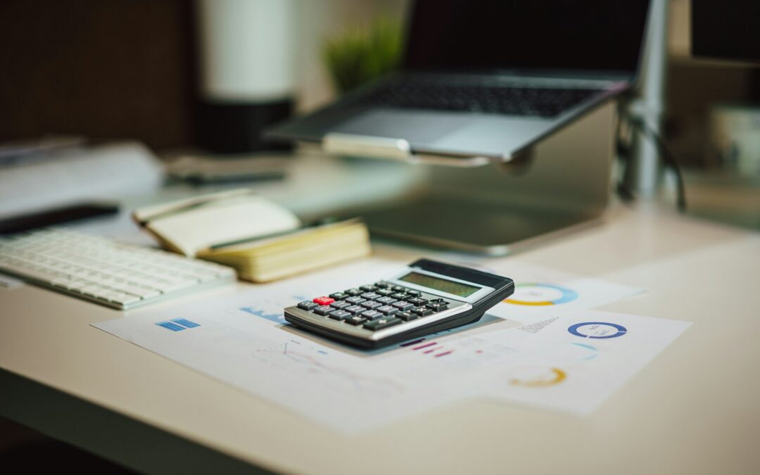 Calculator on a table next to paperwork