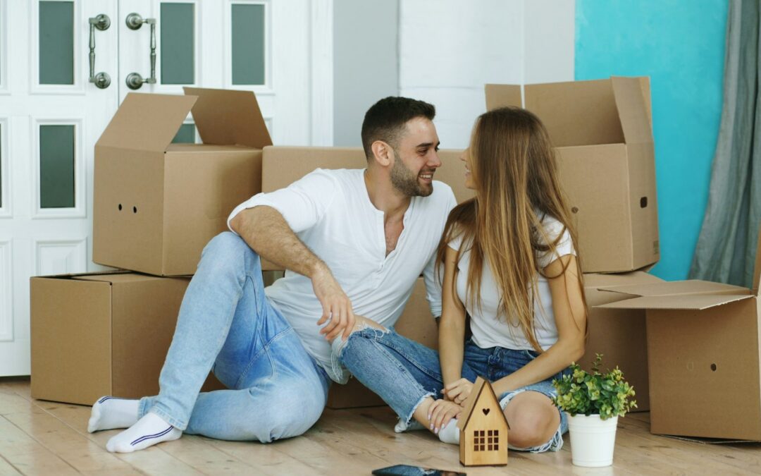 Couple sitting among moving boxes
