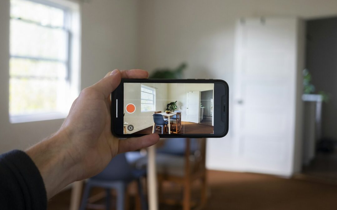 Homeowner taking a photo of a room with a smartphone